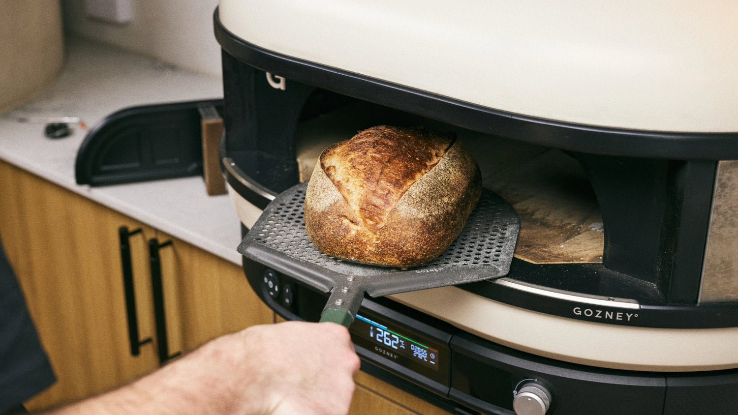 Taking a Sourdough loaf out of the Gozney Dome XL Gen 2 Oven on a Gozney Pro Placement Peel recipe poster image