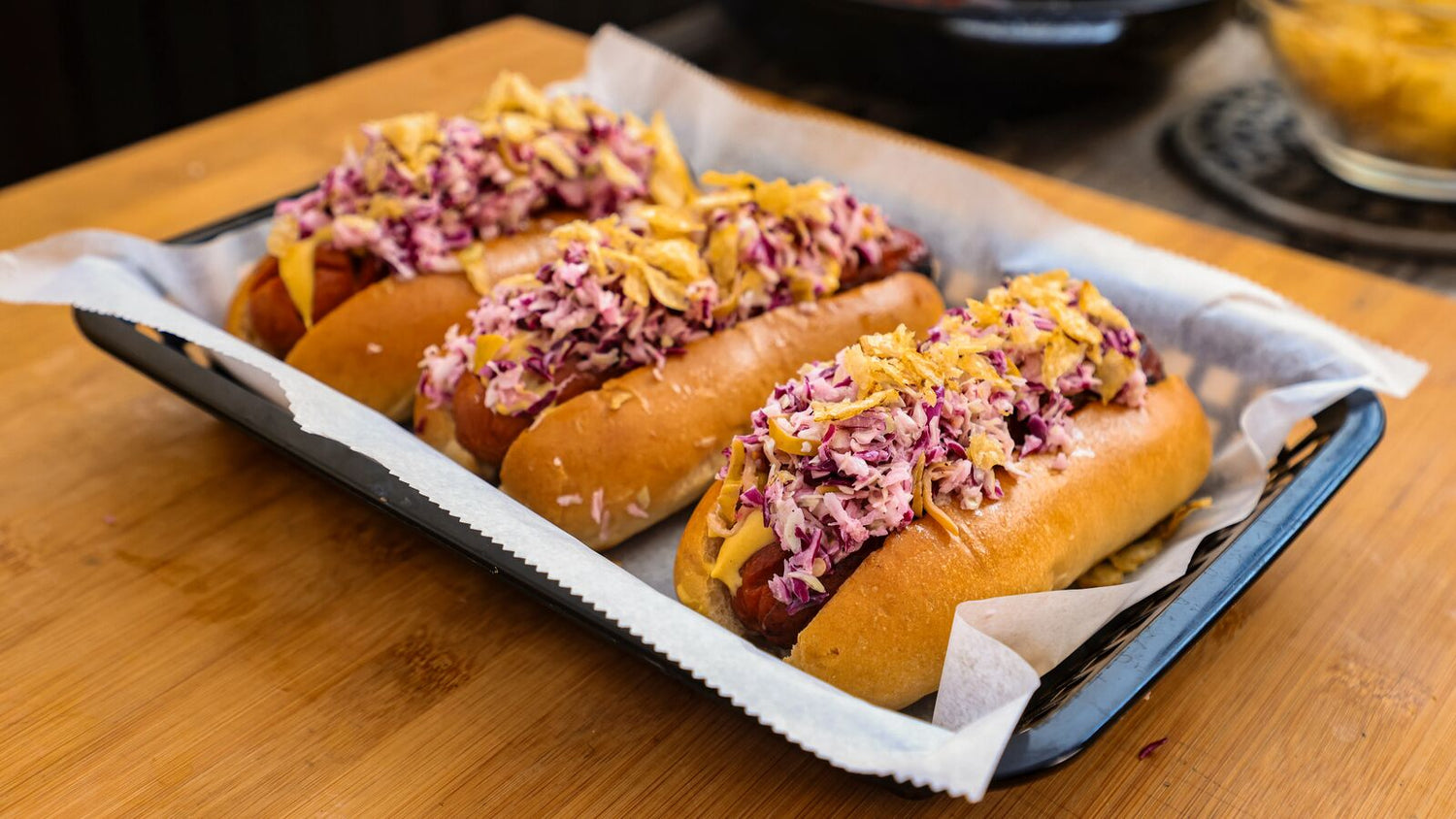 Hot dogs with coleslaw on a deli tray with parchment paper