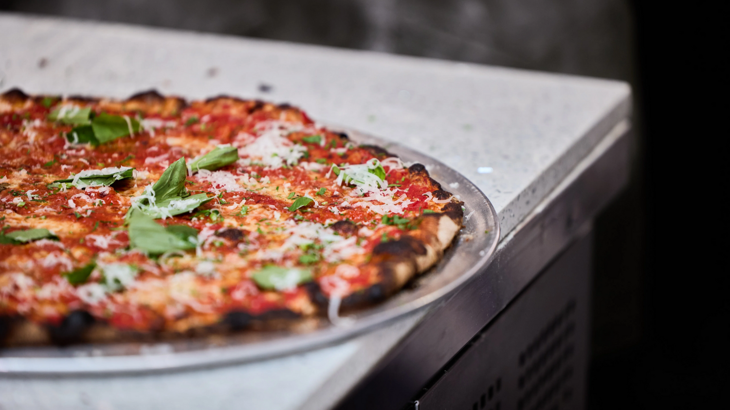 tavern style pizza on the edge of a counter recipe poster image