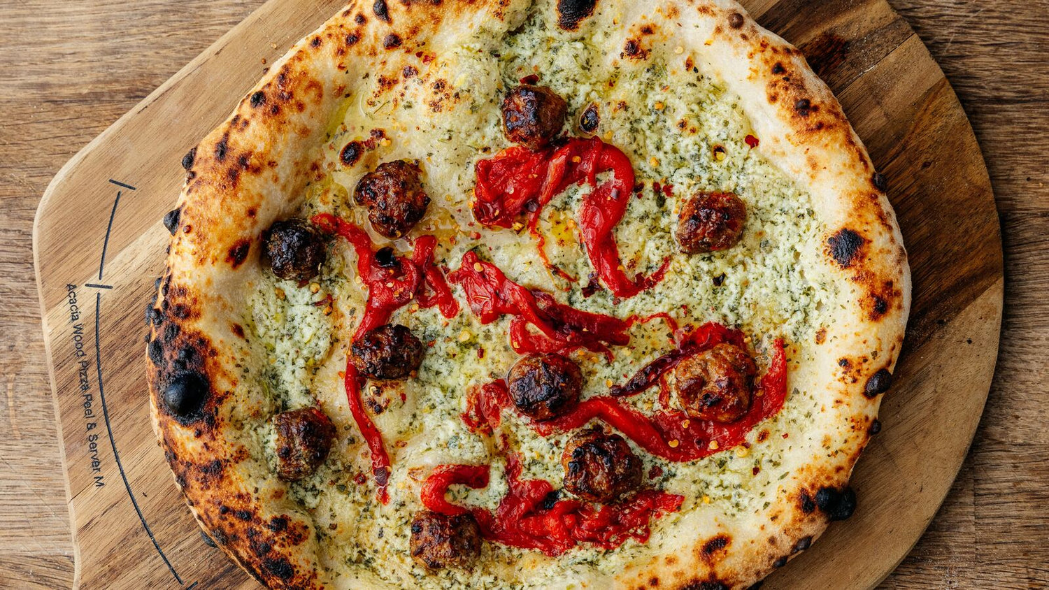 Sausage pizza on a wooden peel recipe poster image